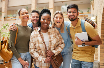 A group of five young adults smiling and posing together indoors, creating a cheerful atmosphere.